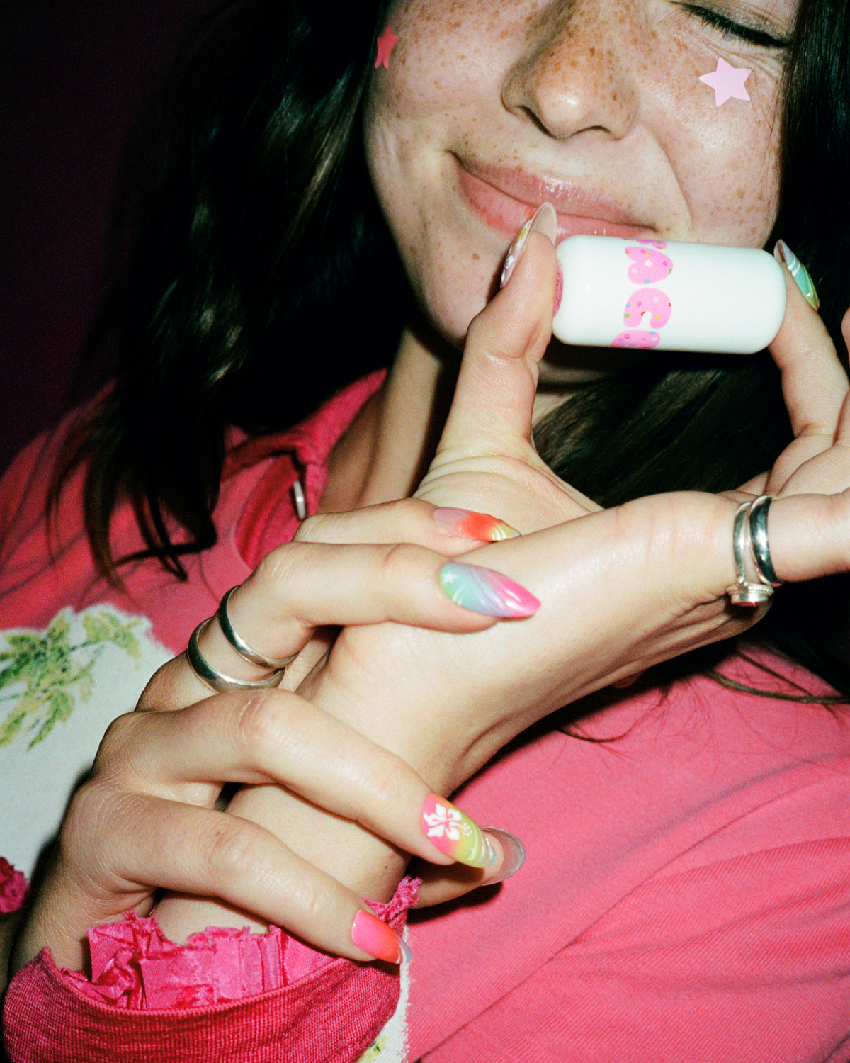 Lifestyle portrait of a person with Starface Star Balm® Bday Cake. A limited-edition birthday cake balm for daily wear.